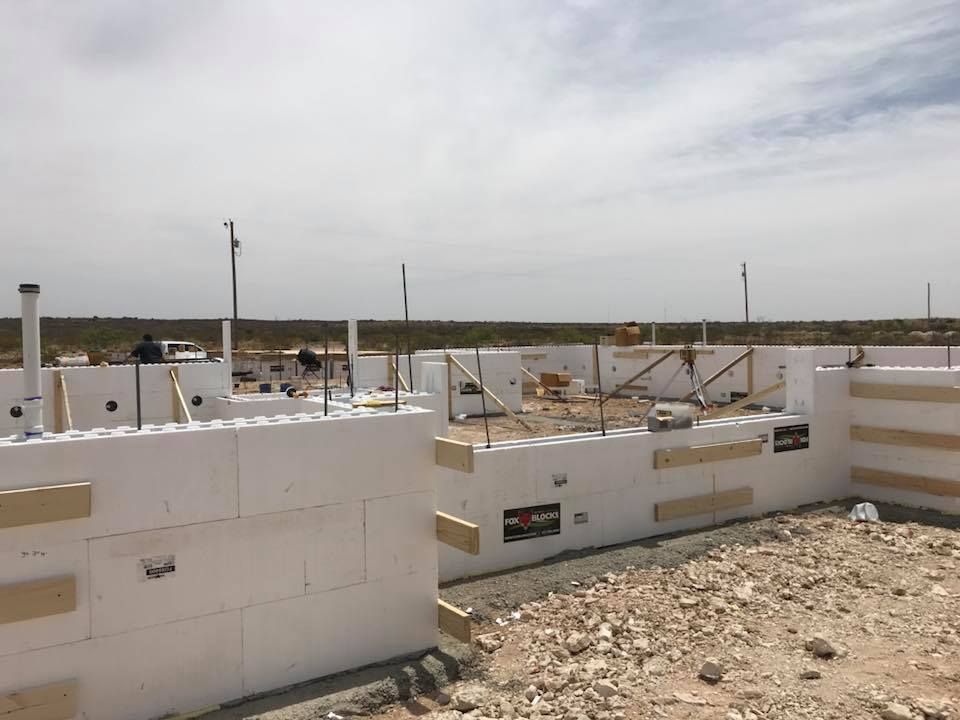 A building is being built in the desert with foam blocks.
