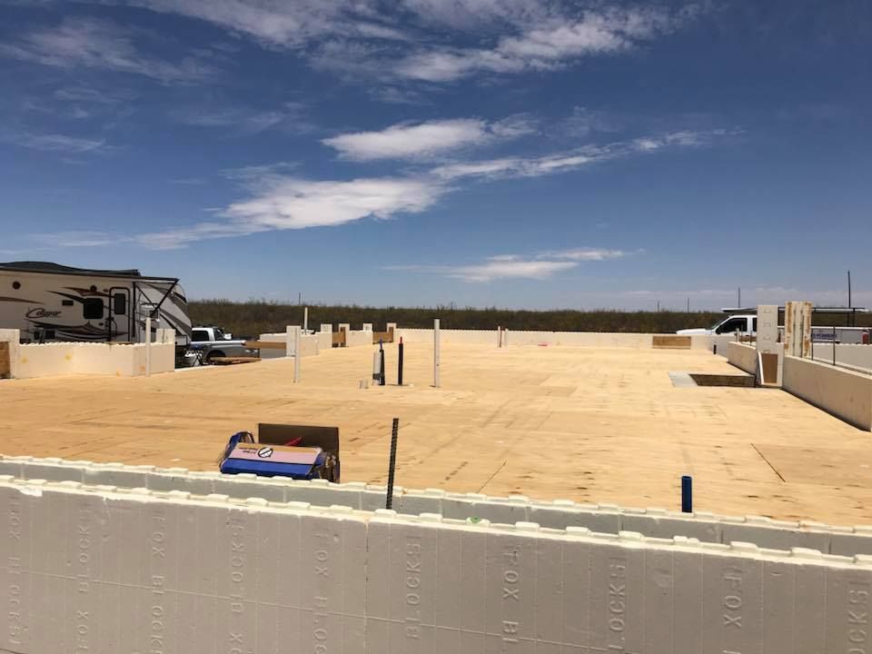 A large building under construction with a blue sky in the background.