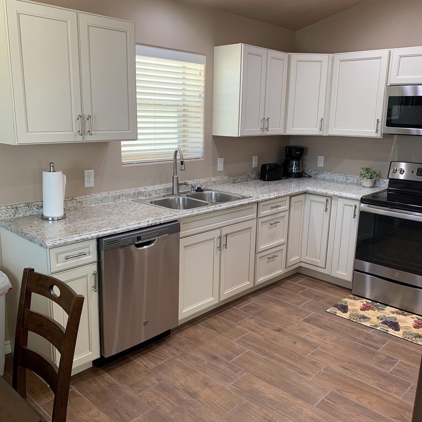 A kitchen with stainless steel appliances and granite counter tops.