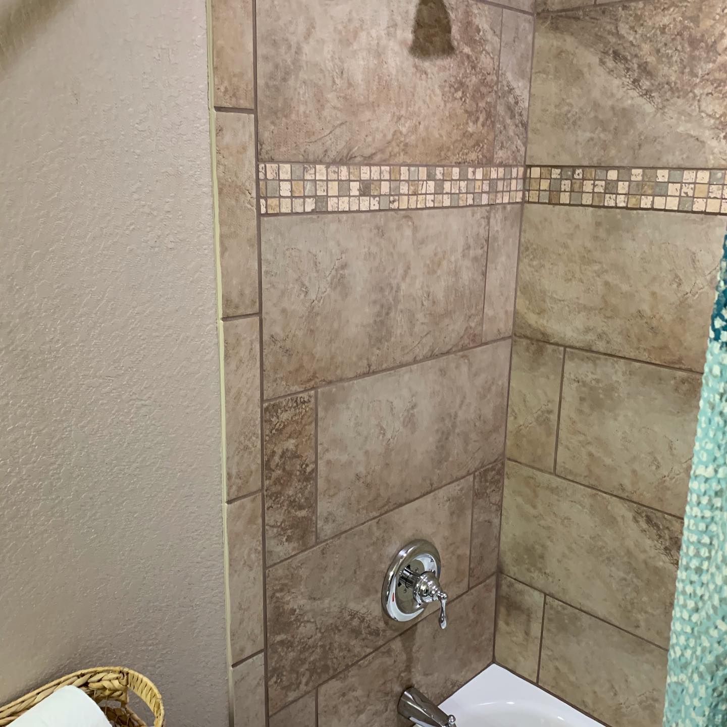 A bathroom with a bathtub and a shower.