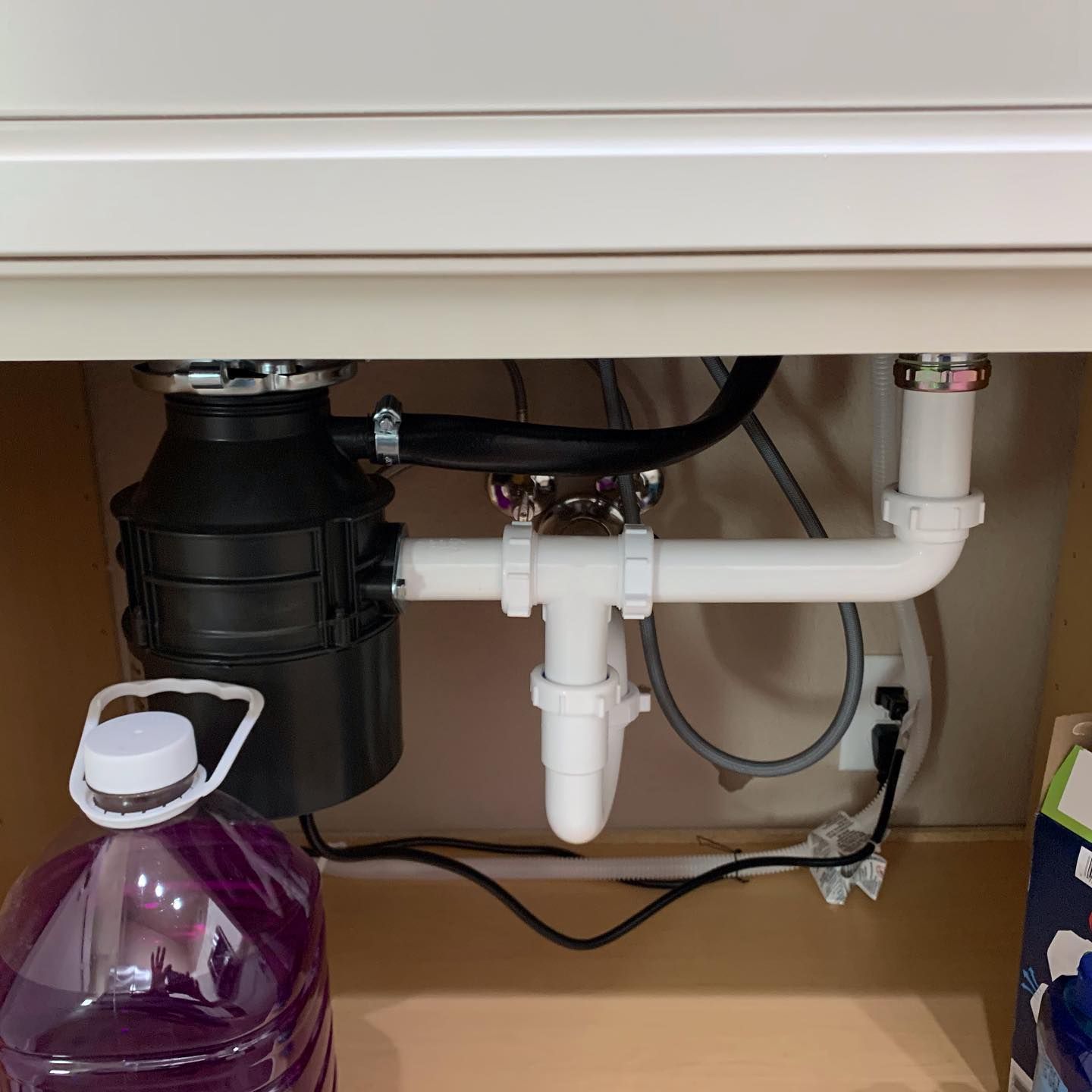 A kitchen sink with a garbage disposal underneath it