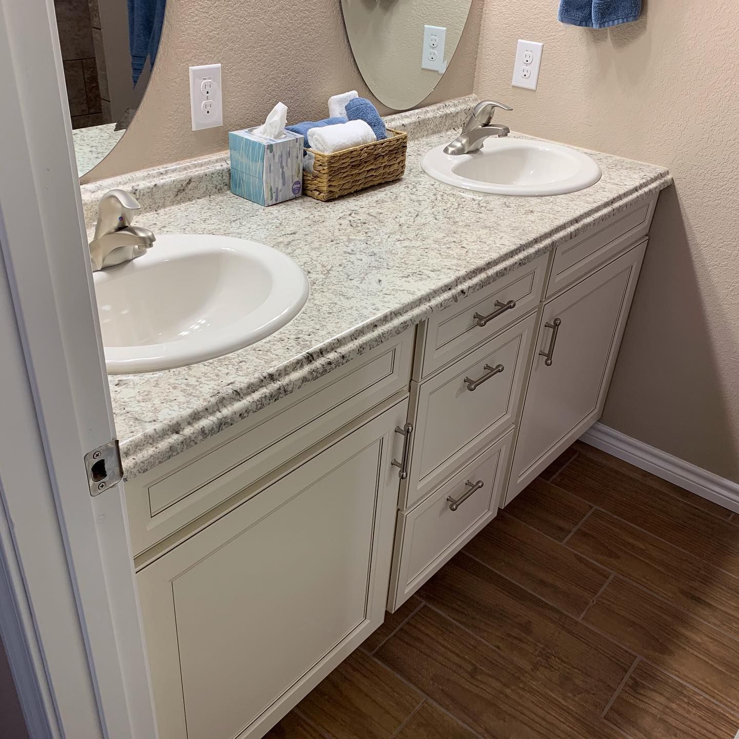 A bathroom with two sinks and a mirror.