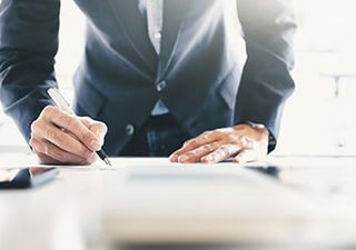Signing papers — Accounting Services in Eugene, OR