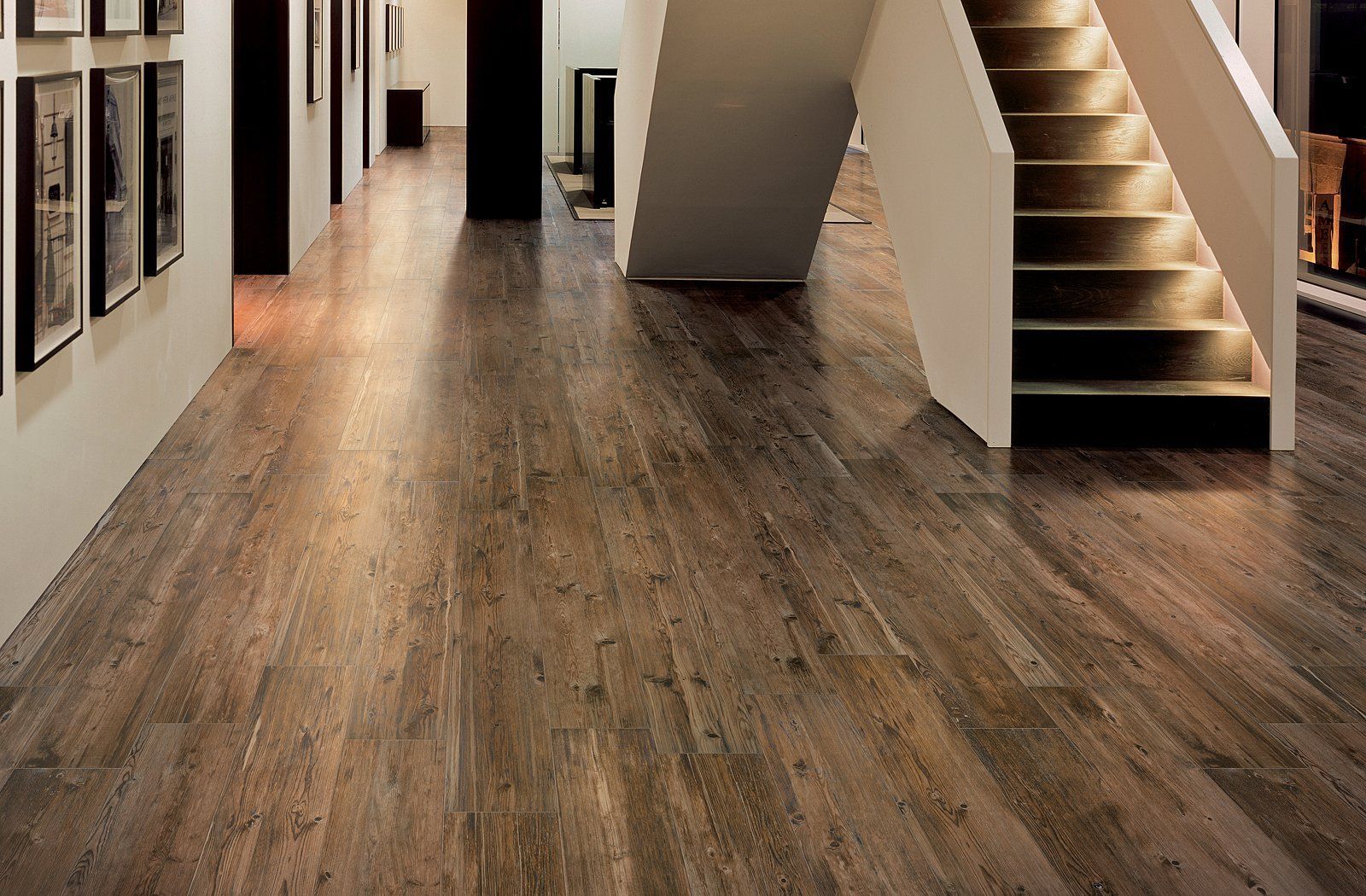 A hallway with a wooden floor and stairs