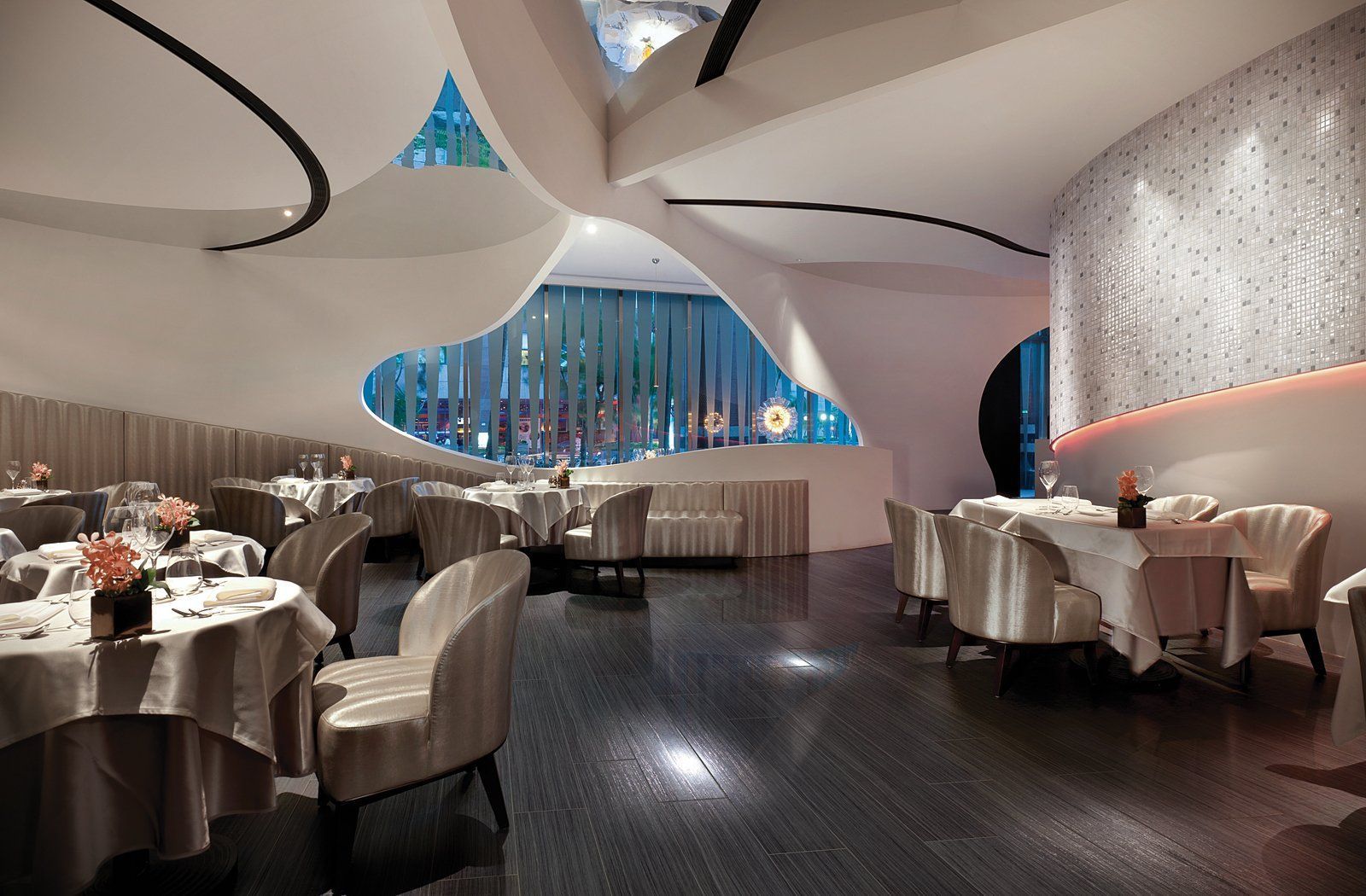 A restaurant with tables and chairs and a large window
