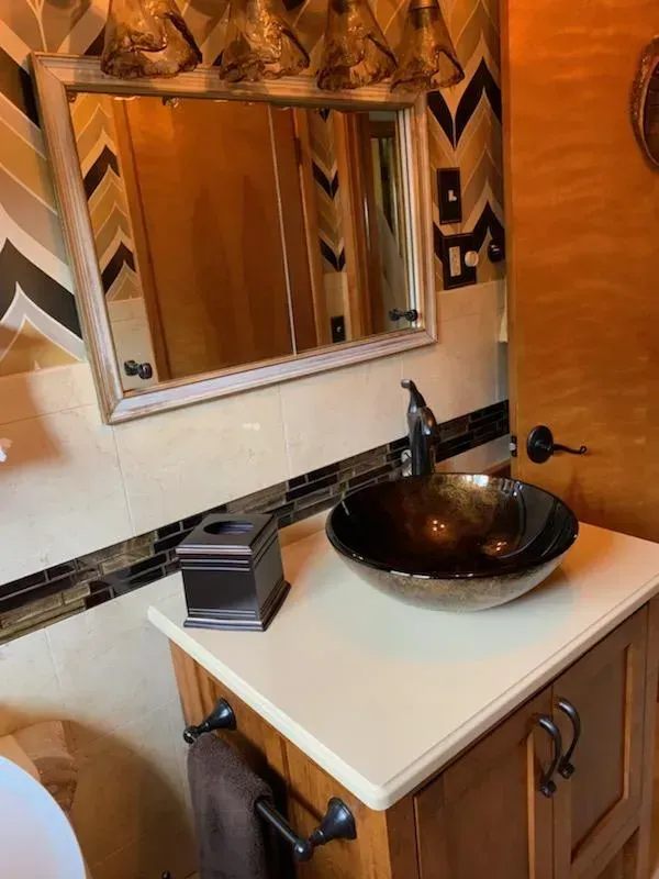 A bathroom with two sinks and two mirrors.