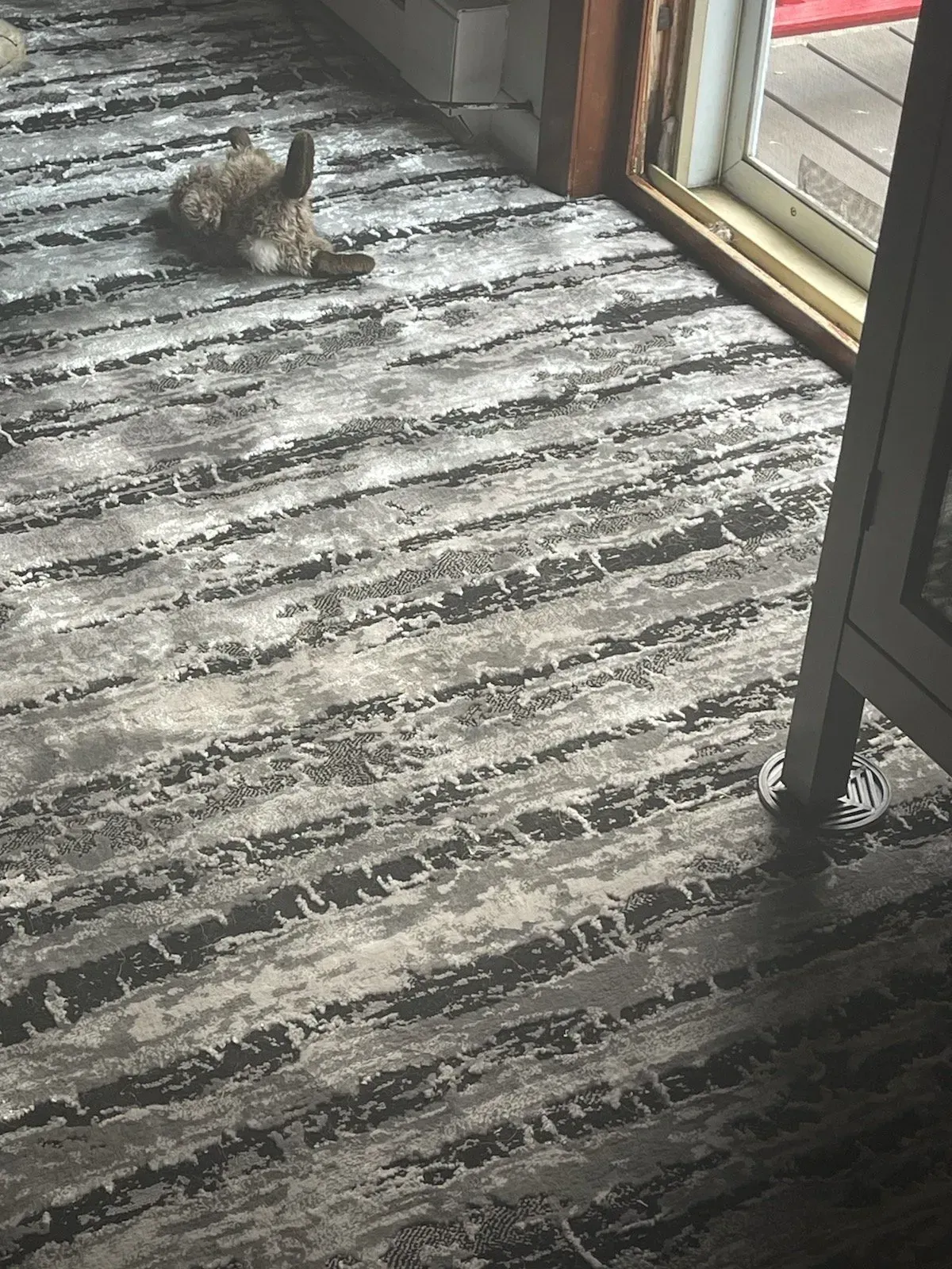 A staircase with a carpeted runner and lights on the railing.