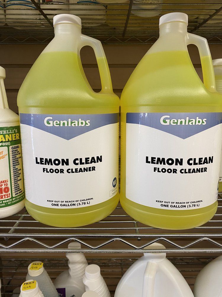 Two yellow gallon jugs of Genlabs Lemon Clean floor cleaner on a shelf.