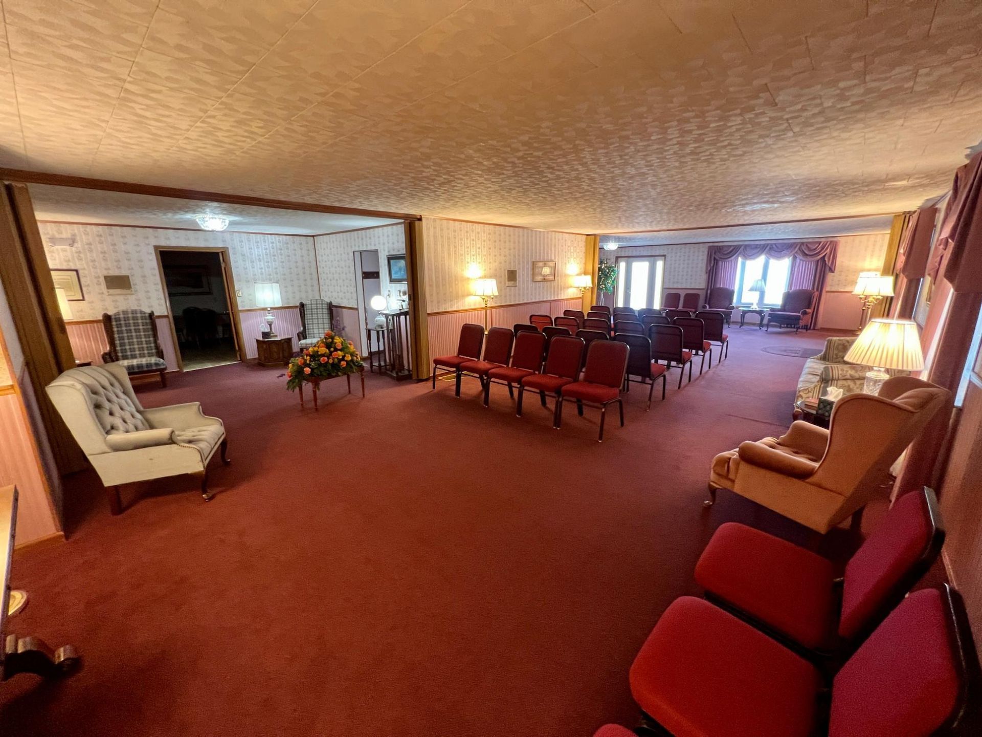A large room with a lot of chairs and tables in it.