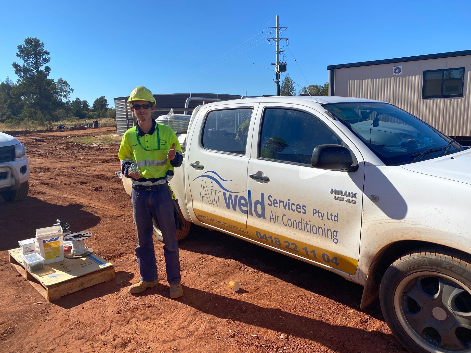Construction worker stands by white 