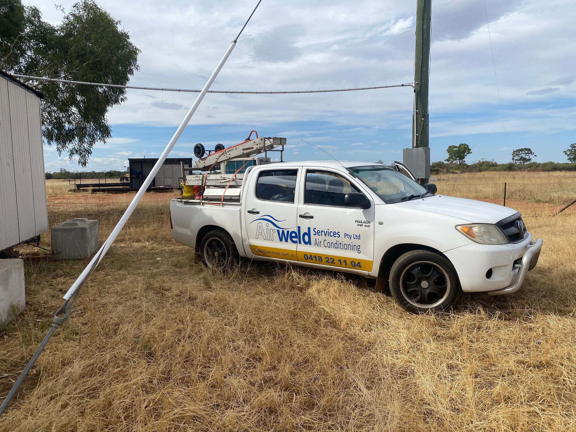 White truck parked in a field; 