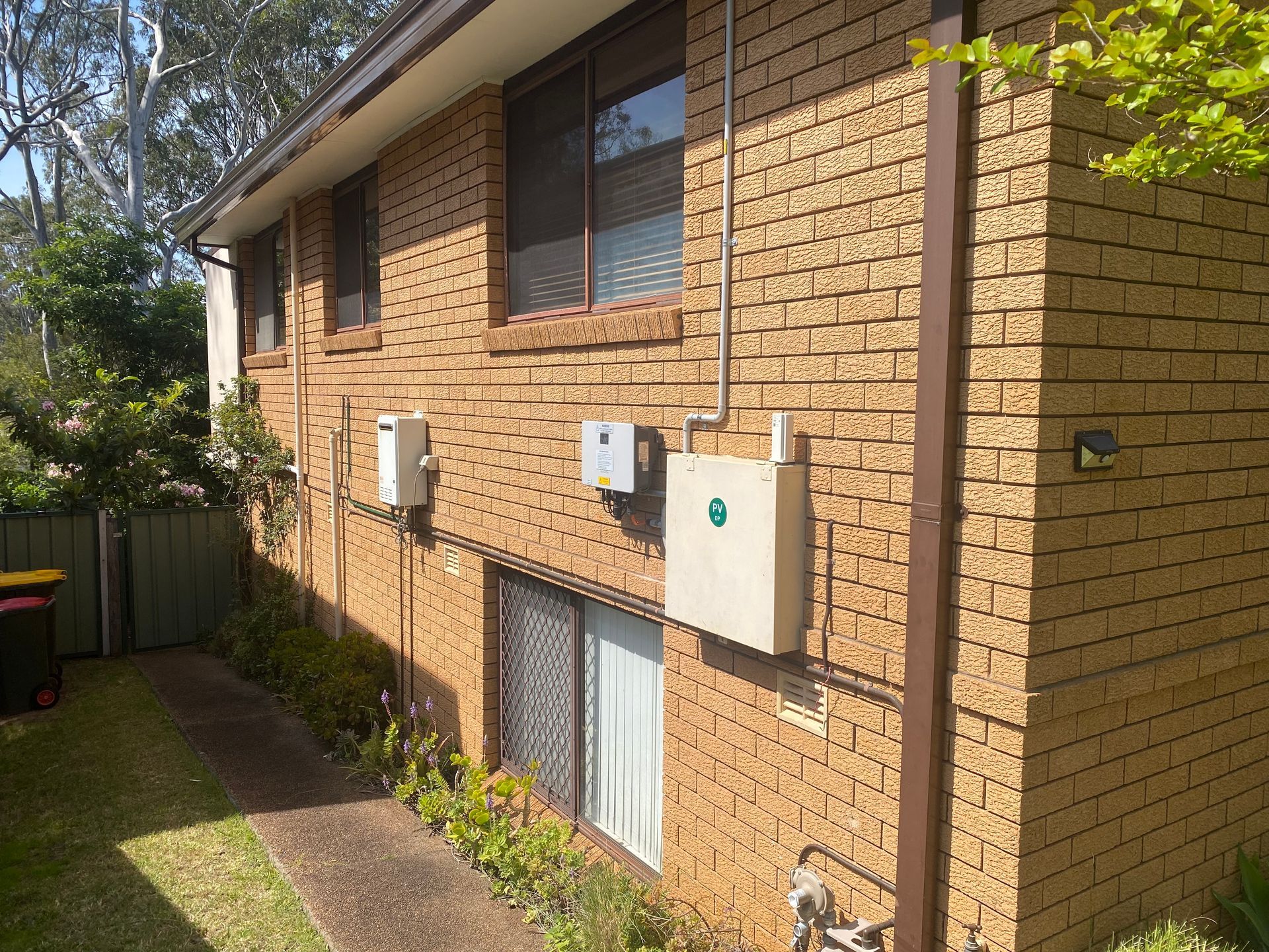 Brick building exterior with utility boxes and a pathway. — Airweld Services Pty Ltd in Ulladulla, NSW