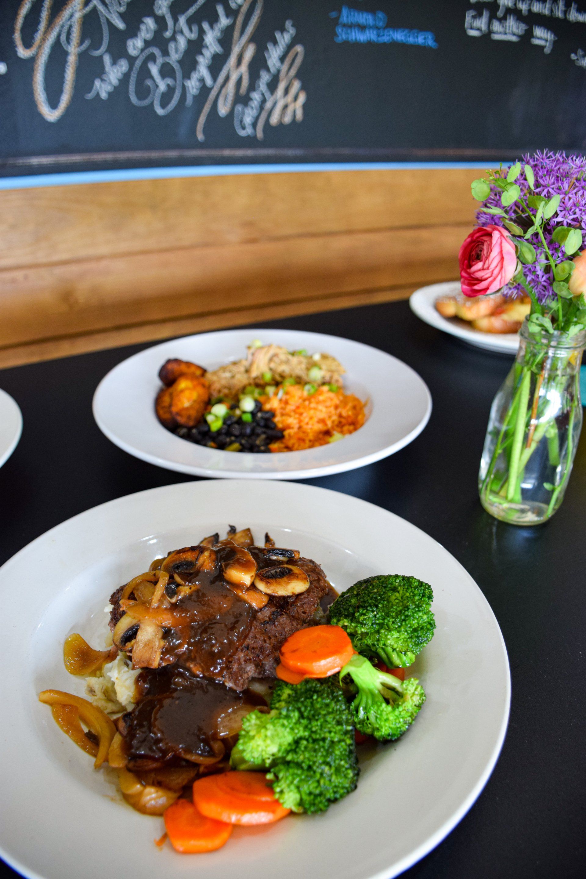 A plate of food with broccoli and carrots on a table