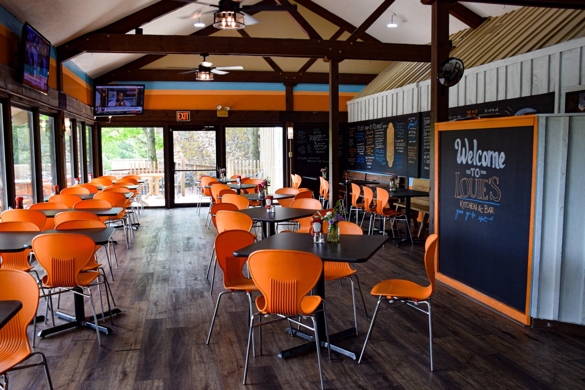 A restaurant with tables and chairs and a welcome sign