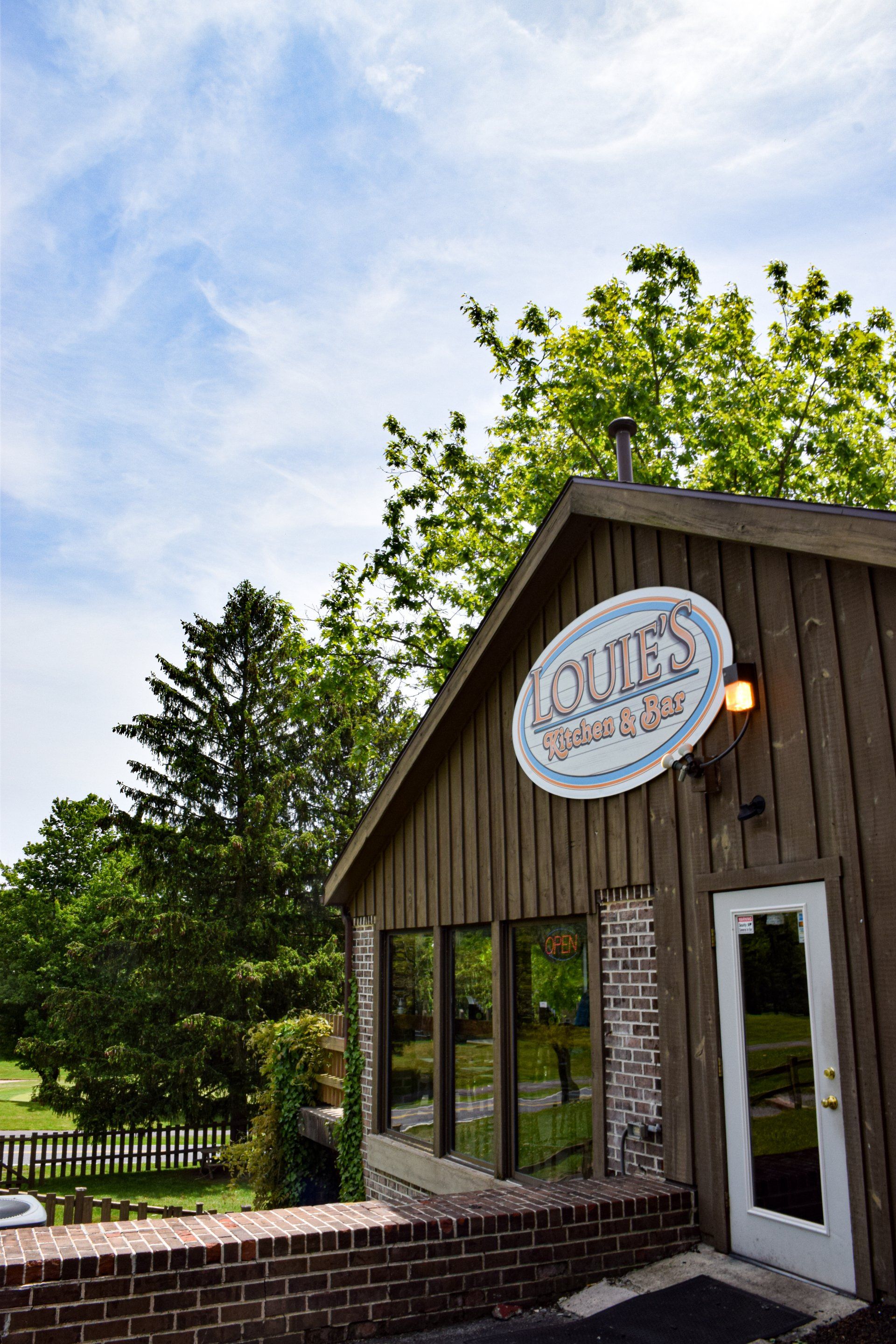 A large wooden building with a sign on the side of it.