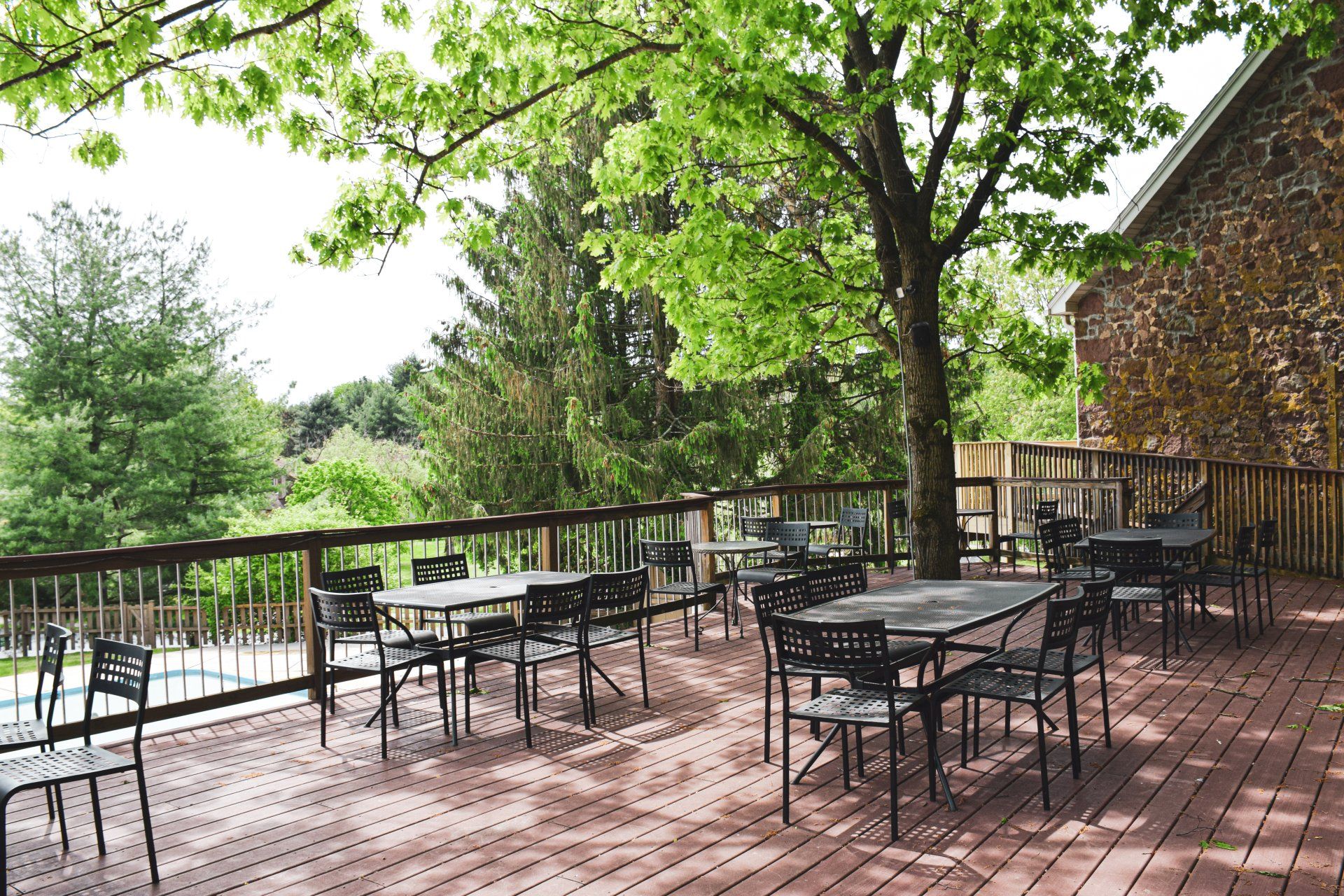 There are many tables and chairs on the deck.