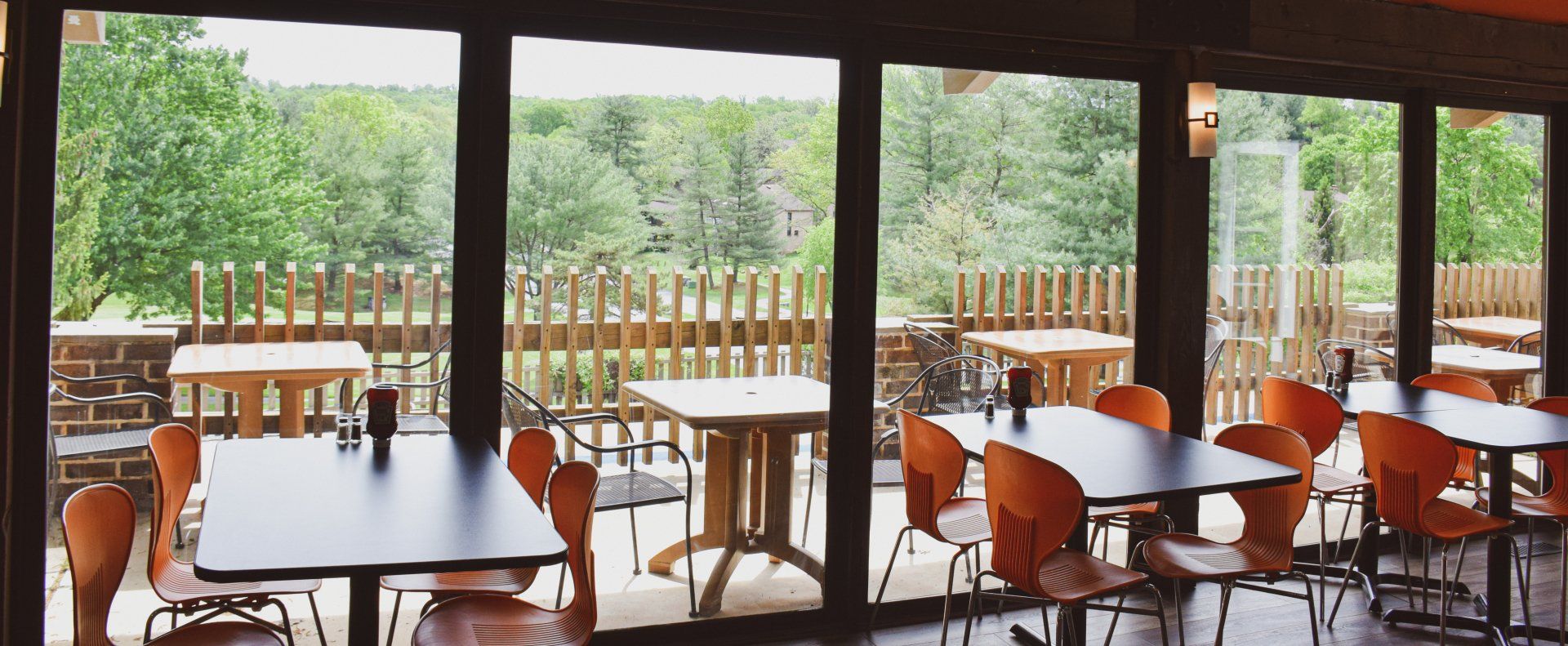 A restaurant with tables and chairs and lots of windows