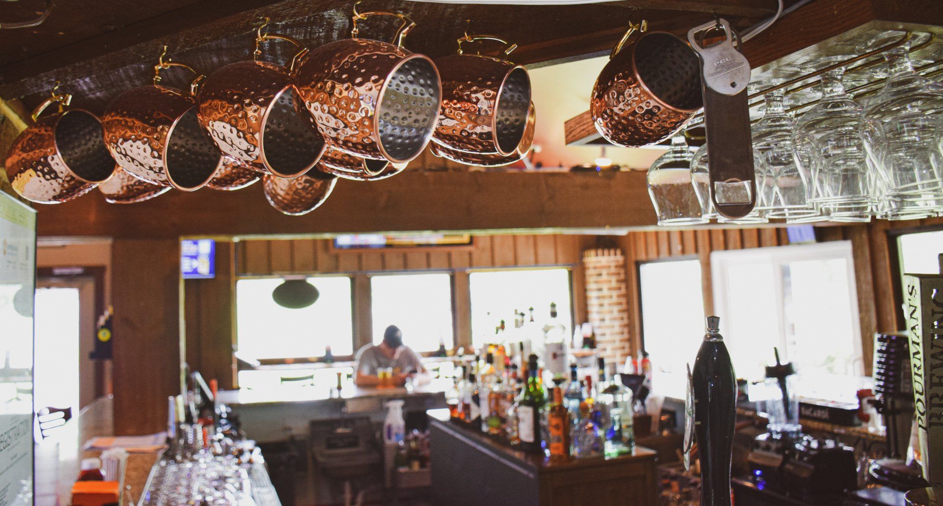 A bar with copper pots hanging from the ceiling