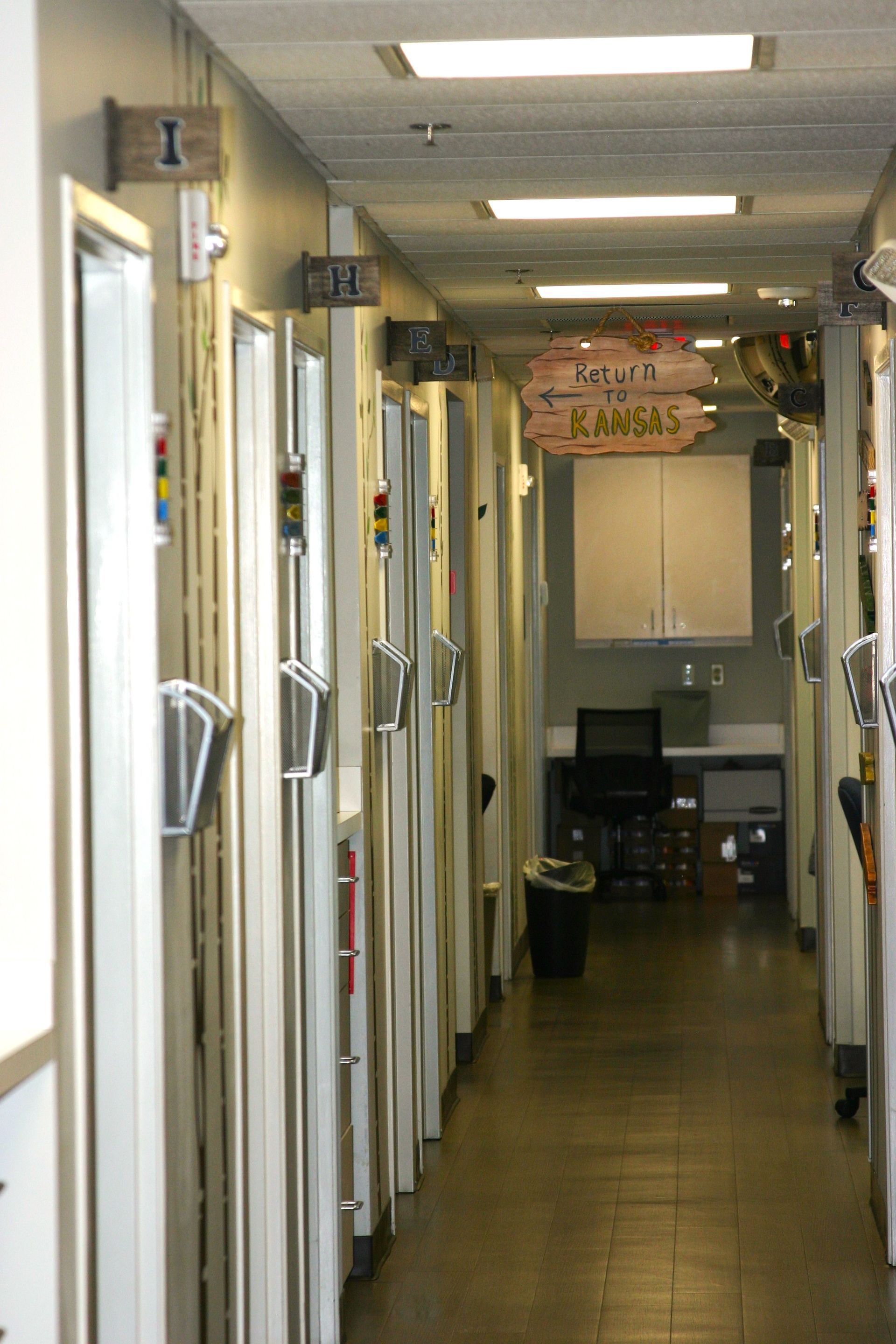 A long hallway with a sign on the wall that says 1