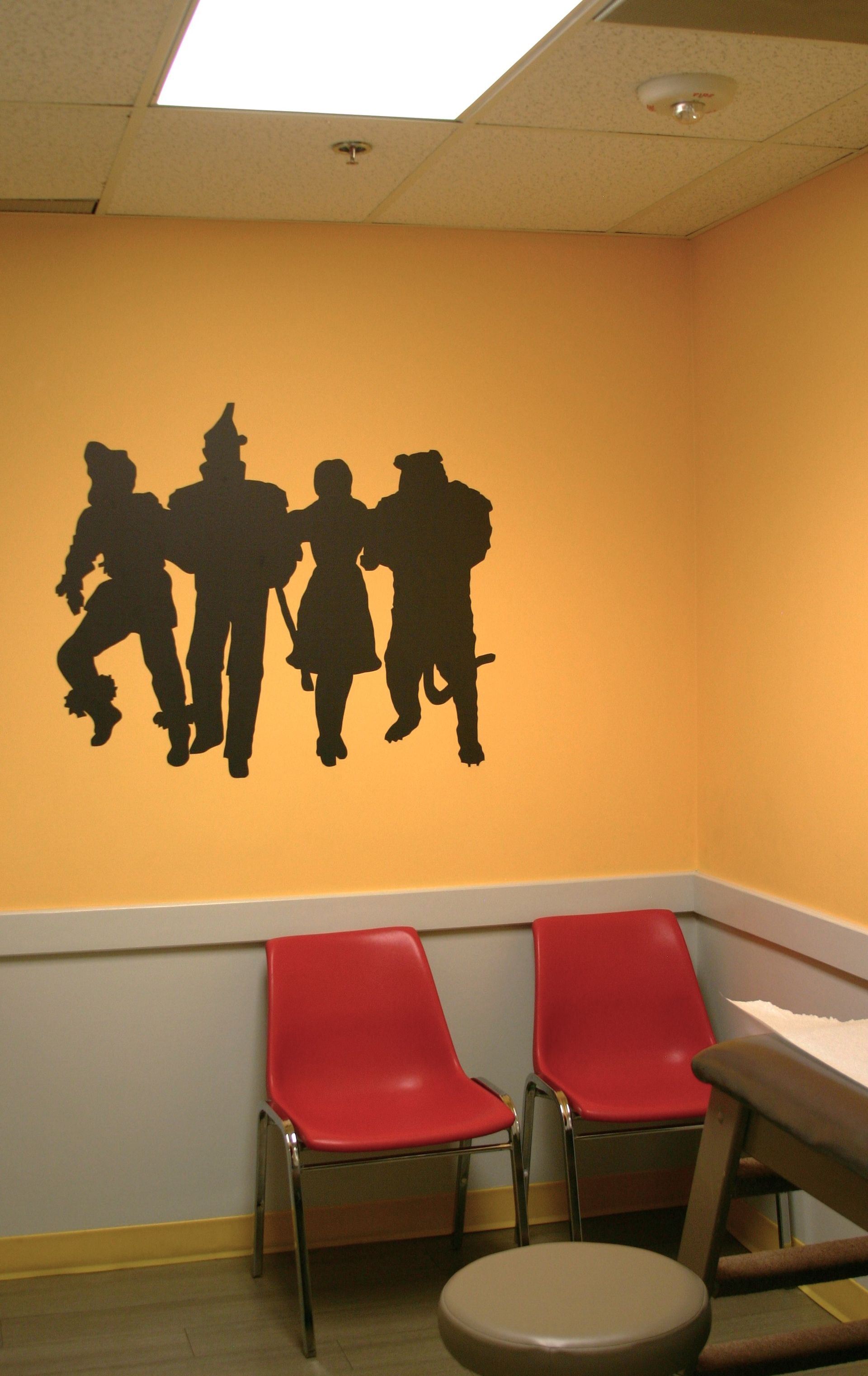 A waiting room with a silhouette of the wizard of oz on the wall