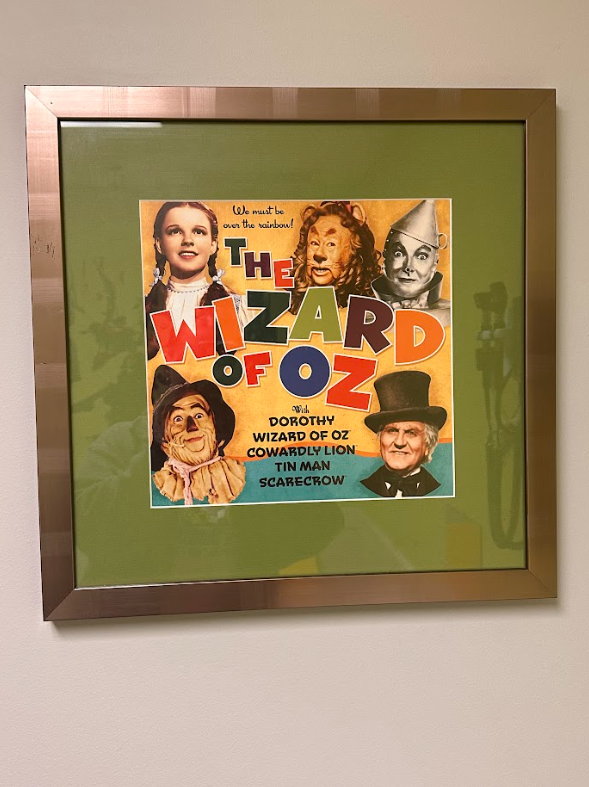 A framed movie poster for the wizard of oz