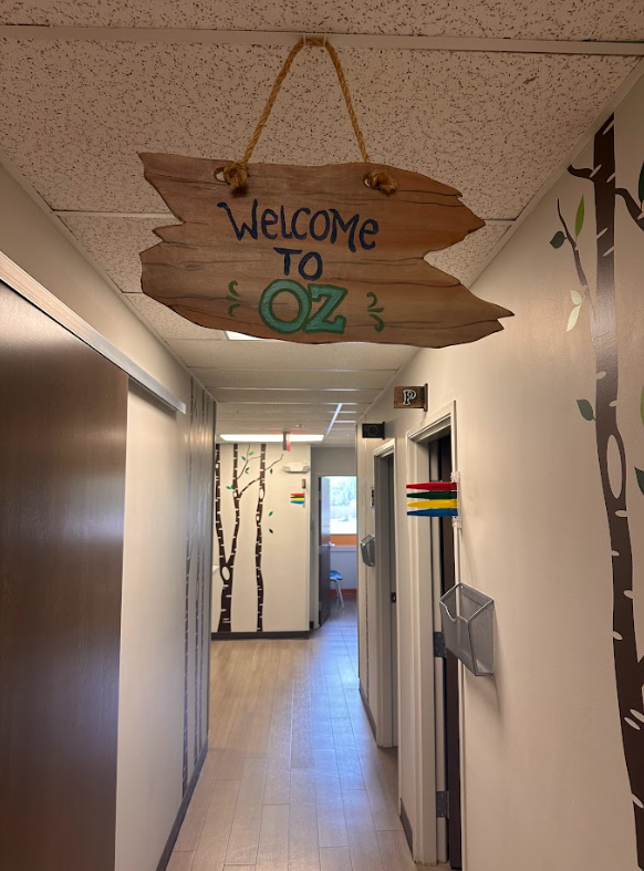 A hallway with a welcome to oz sign hanging from the ceiling