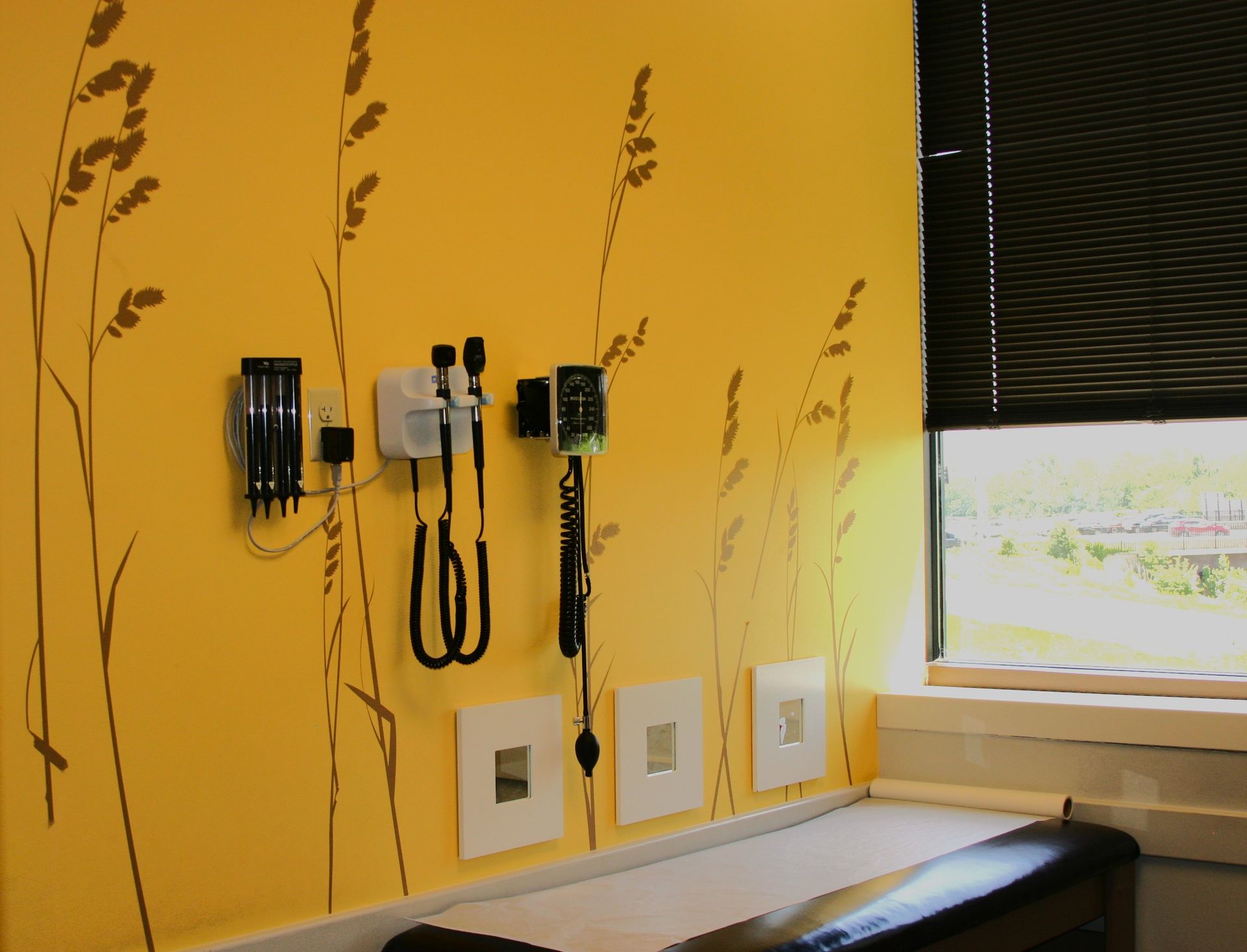 A doctor 's office with a yellow wall and a window