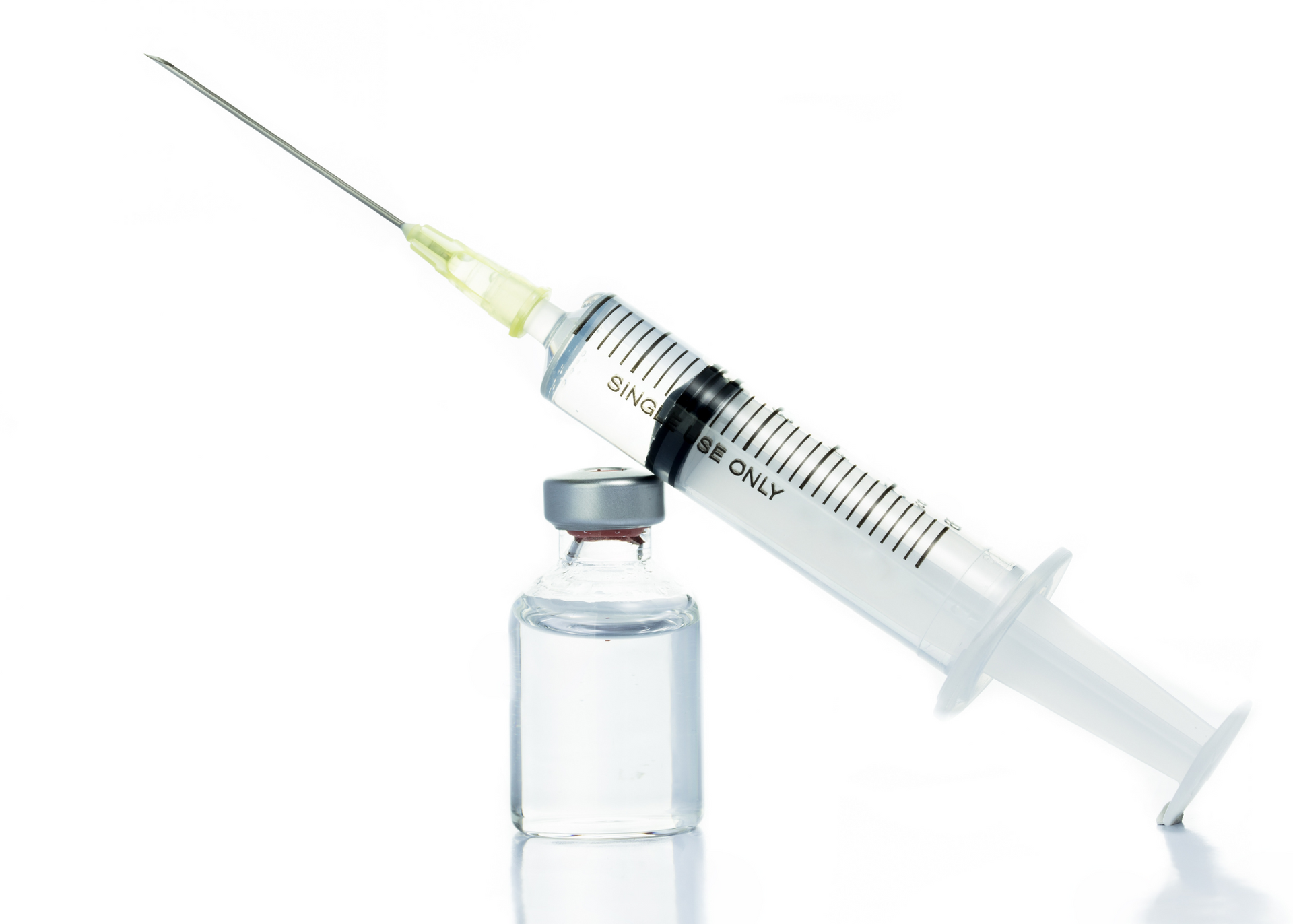 A woman is getting a botox injection in her lips.