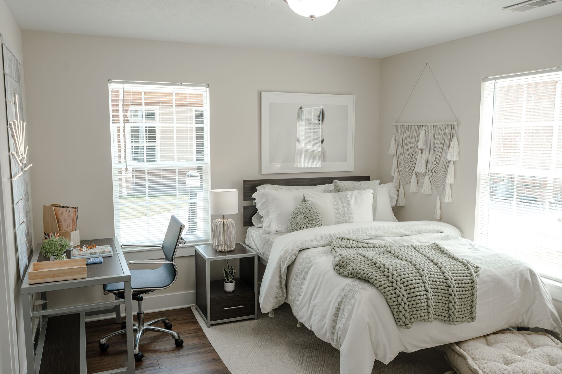 Bar with stone wall, shelves with decorations, pendant lights, and bar stools.