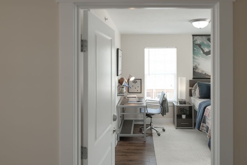 Cozy living room with couches, fireplace, TV, and decorative wall art.
