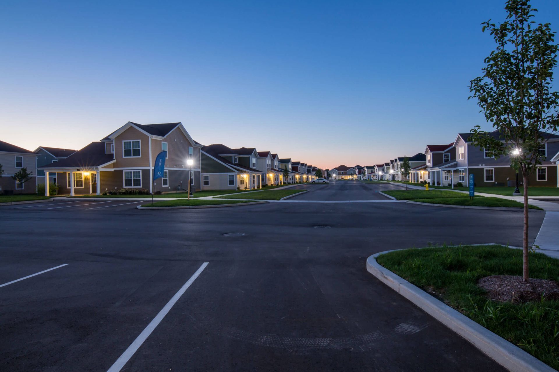 Evening view or parking lot and apartment building. 
