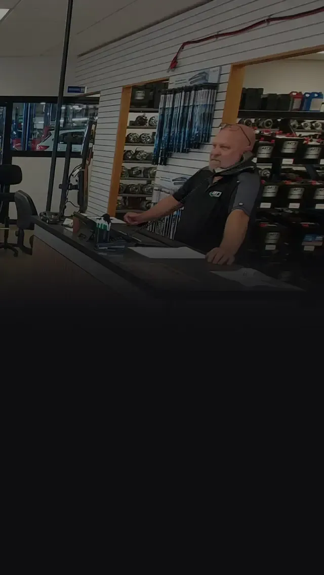 Staff on phone at receptionist desk | Art's Automotive