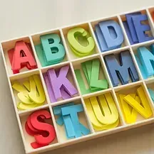 A tray filled with colorful letters of the alphabet.