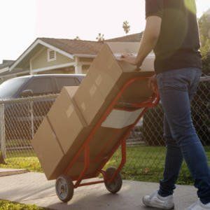 boxes on a push cart getting dropped off