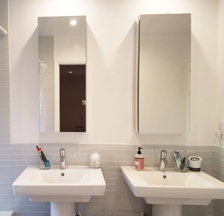 A bathroom with two sinks and two mirrors