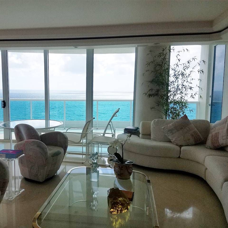 A living room with a view of the ocean