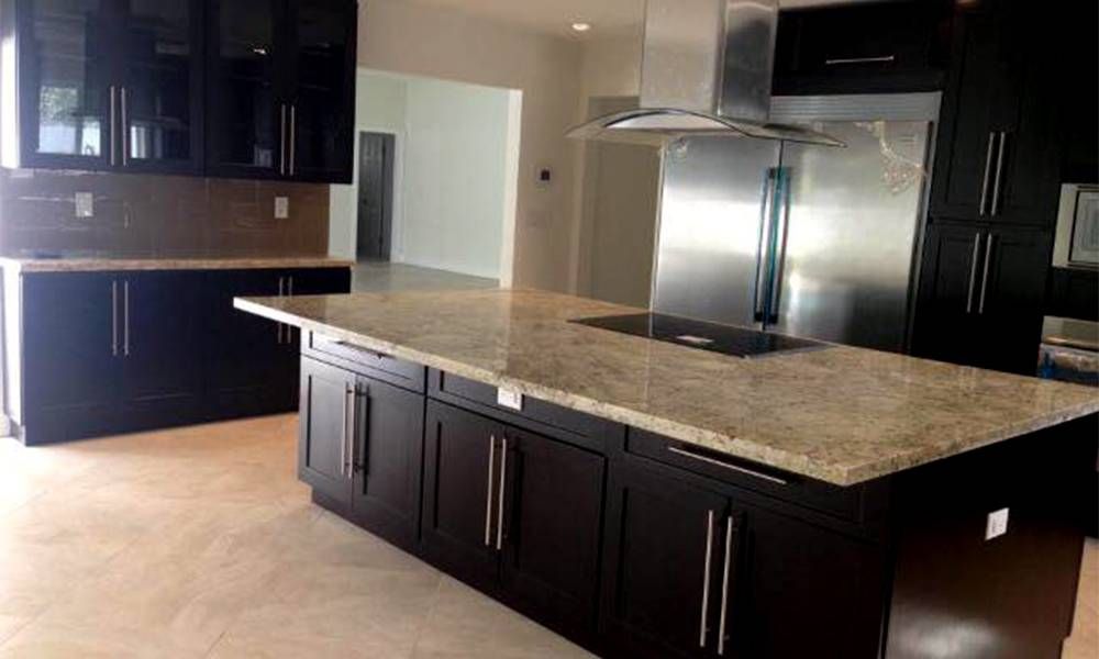 There is a large island in the middle of the kitchen.