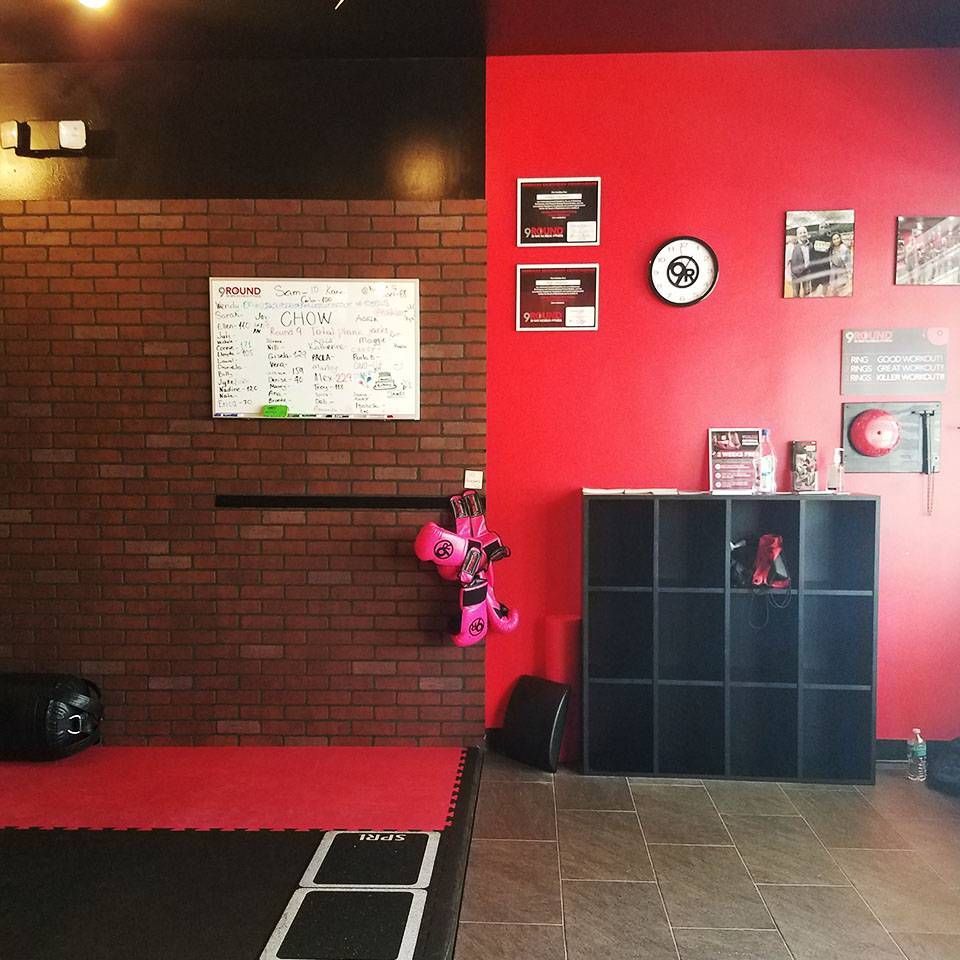 A room with a red wall and a black shelf