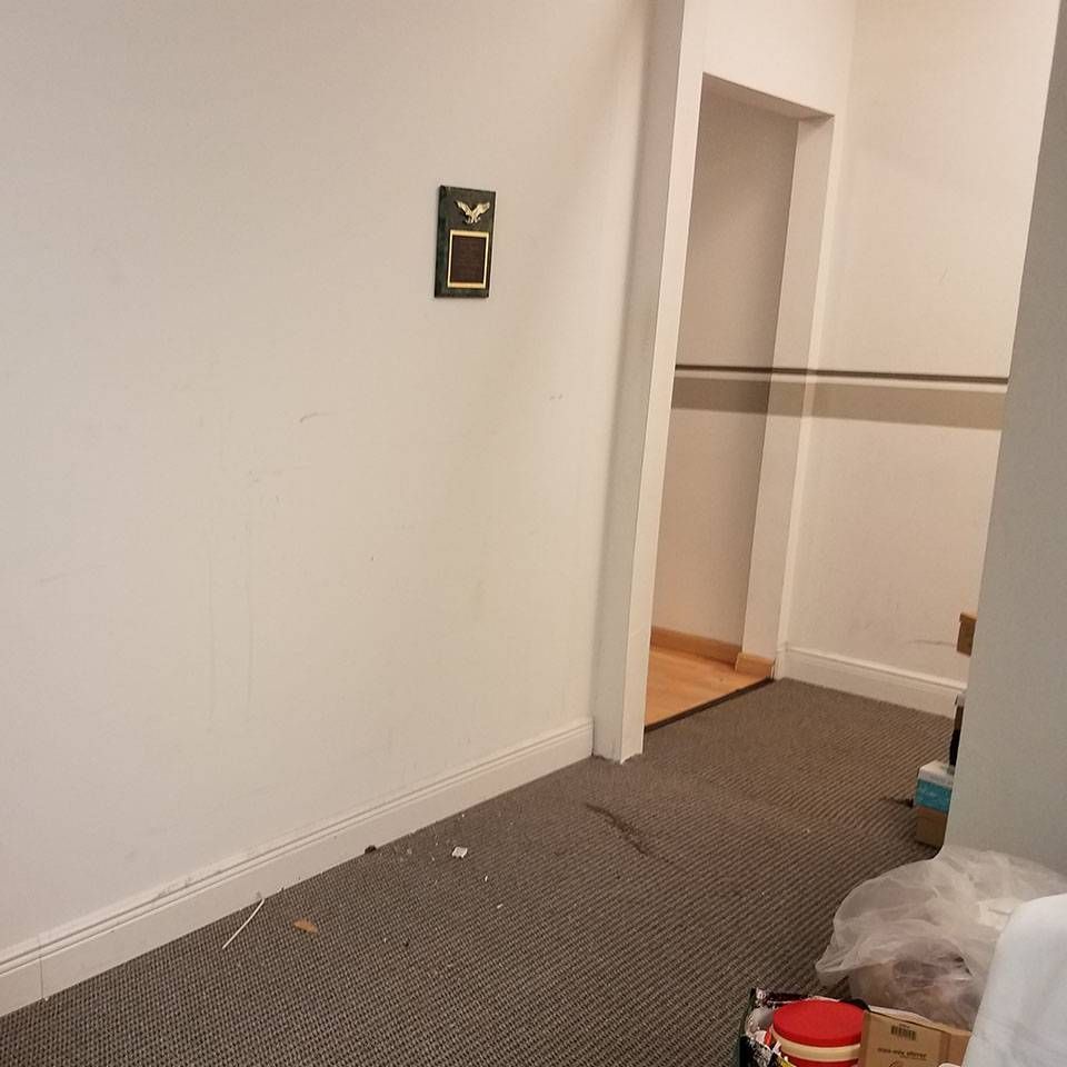 A hallway with a sign on the wall that says ok