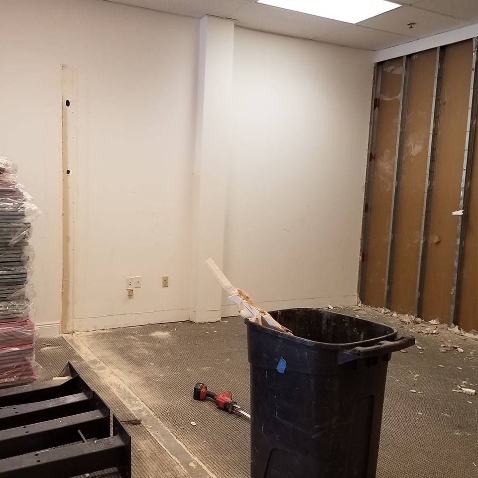 There is a trash can in the middle of the room.