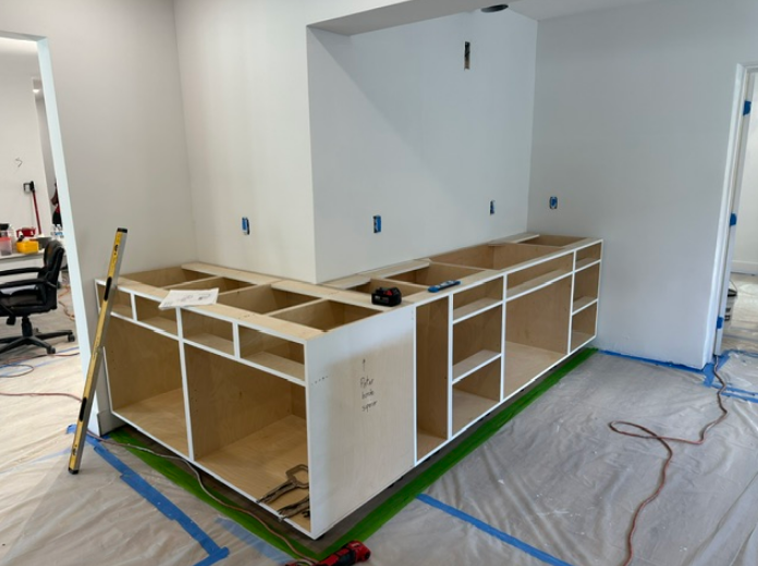 A kitchen is being remodeled and the cabinets are being built