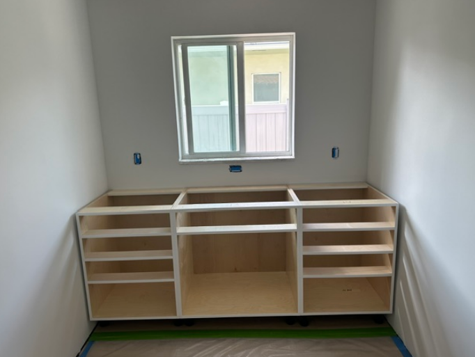 A room with shelves and a window in it