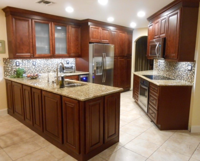 A kitchen with wooden cabinets and granite counter tops