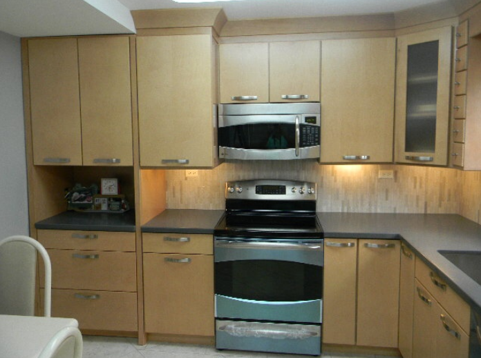 A kitchen with stainless steel appliances and wooden cabinets