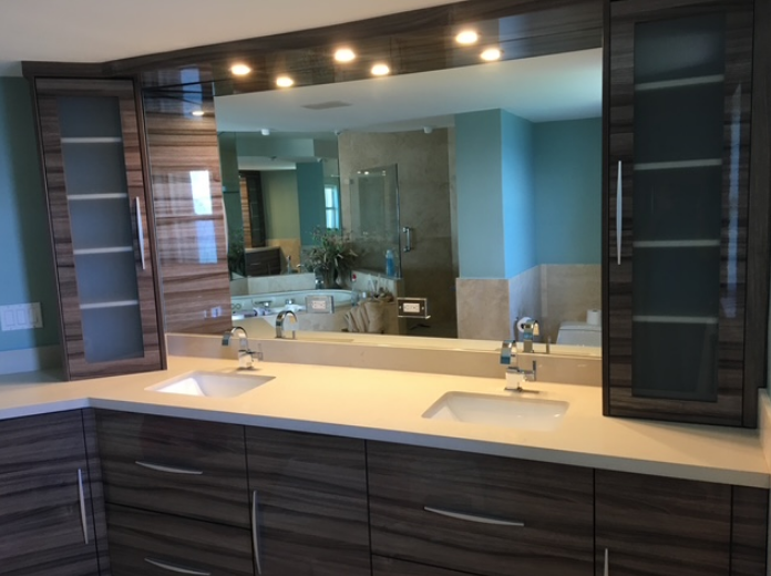 A bathroom with two sinks and a large mirror