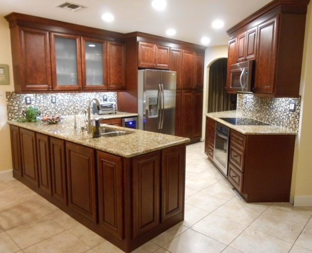 A kitchen with wooden cabinets and granite counter tops