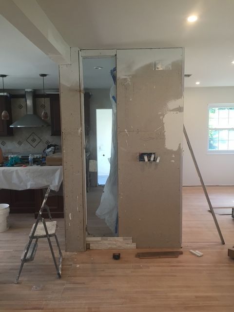 A room that is being remodeled with a ladder in the foreground