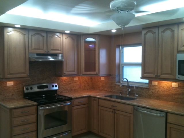 A kitchen with stainless steel appliances and wooden cabinets