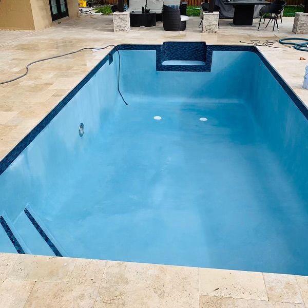 A large swimming pool with a chair in the middle of it