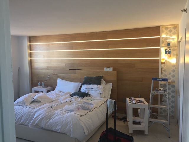 A bedroom with a bed and a ladder in it